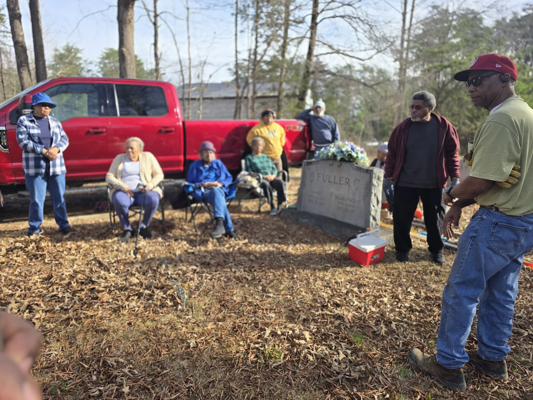 Community members gathered at Snow Hill Cemetery during the headstone reset work day
