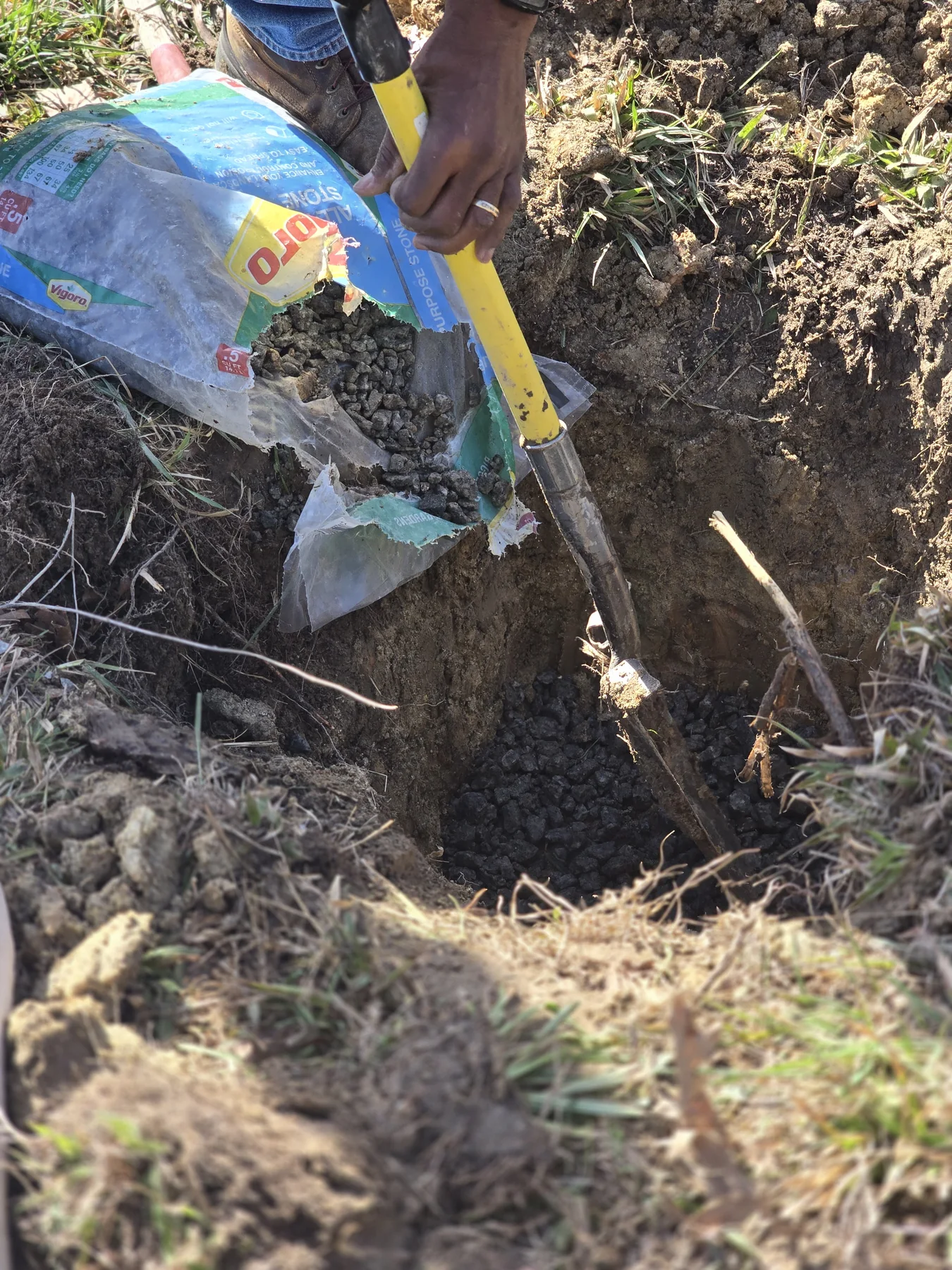 Volunteers preparing the foundation area before resetting a historic headstone